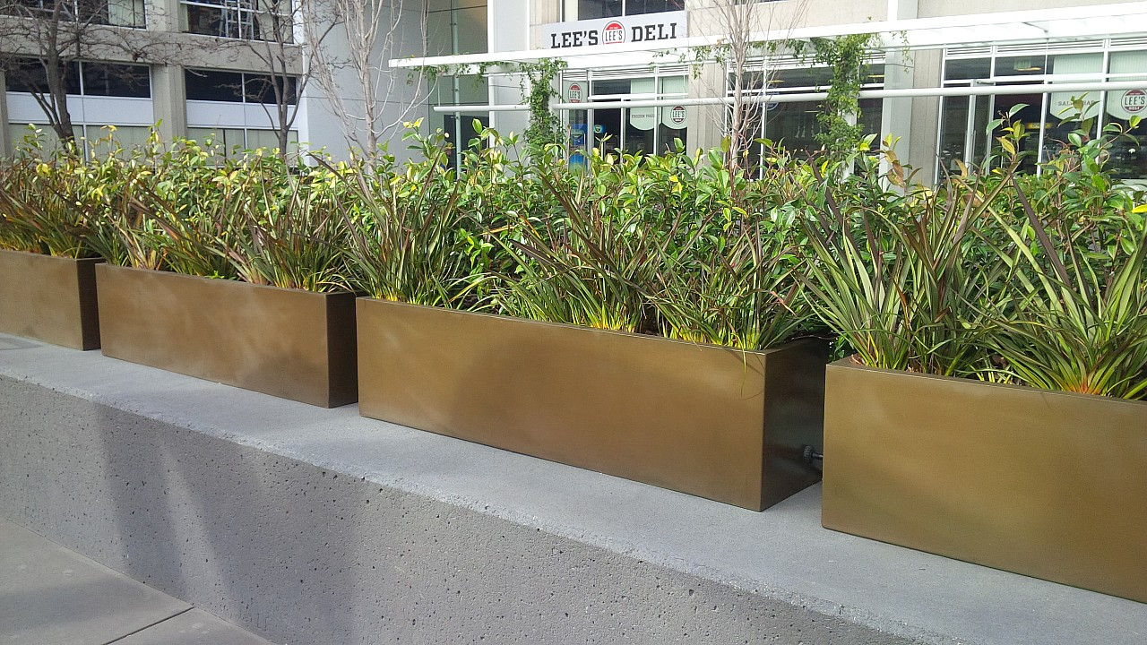 brown rectangular planter outside the building